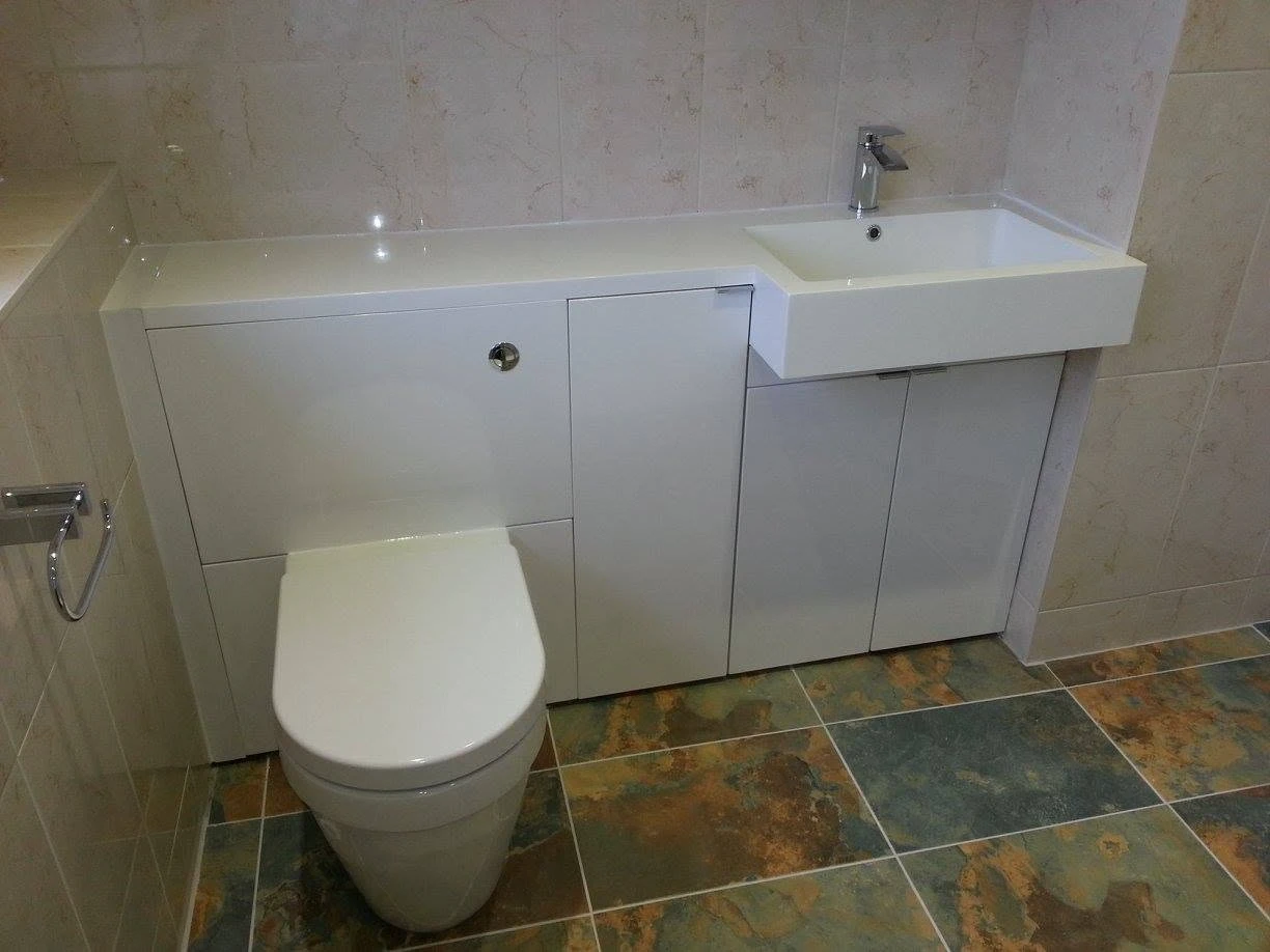 tiled floor with toilet connected to sink