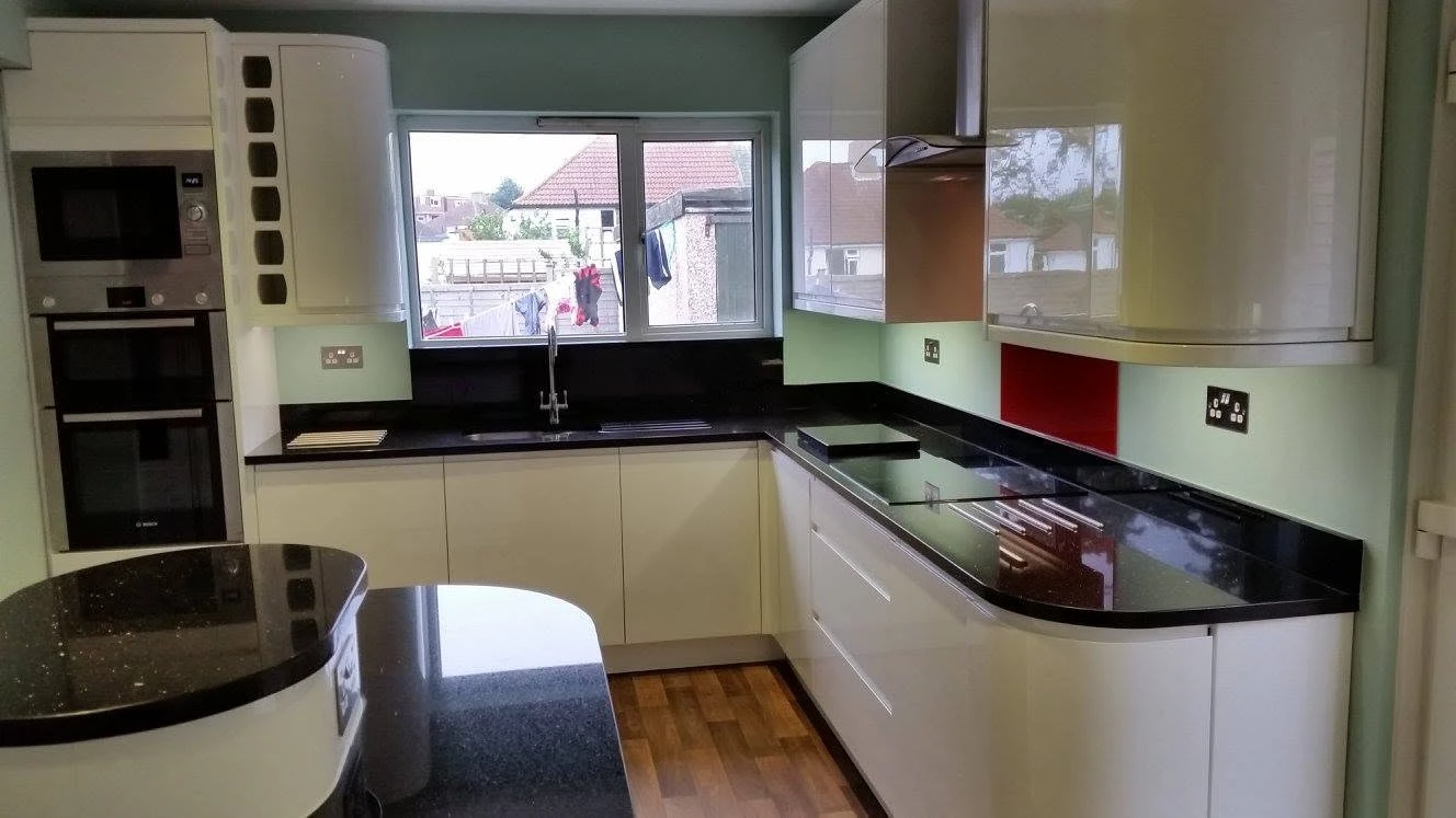 wooden floor kitchen with black kitchen tops