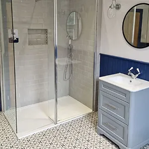 a bathroom with a walk in shower next to a sink