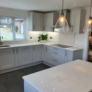 a kitchen with a large white counter top